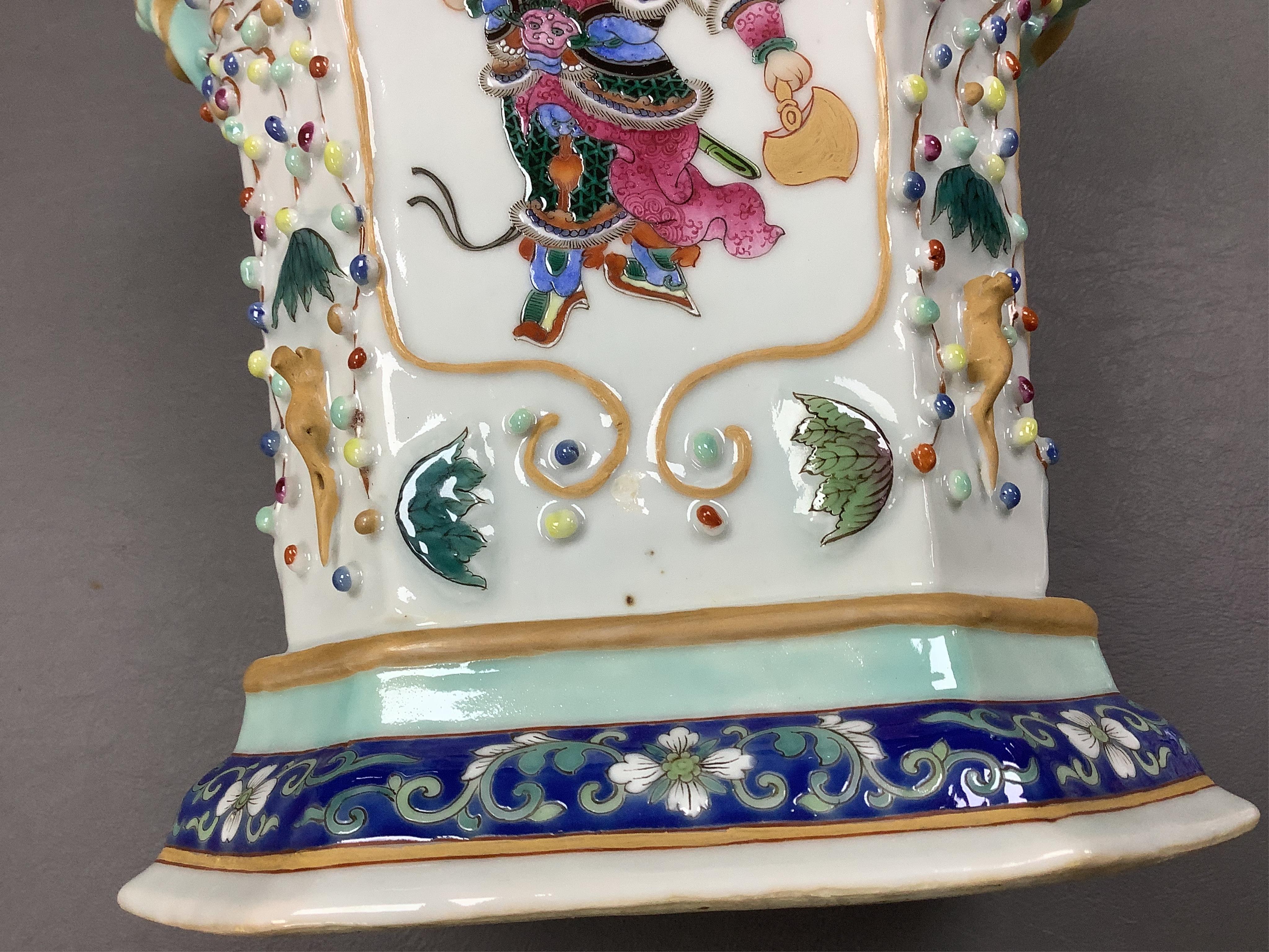 A pair of Chinese famille rose bough pots, painted with figures and calligraphy, 24cm high. Condition - one cover damaged